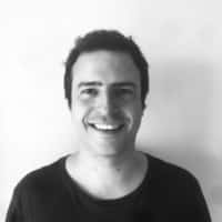 Portrait of TIOMarkets Group CEO Stefanos Mitsi with leadership summary text highlighting executive team roles